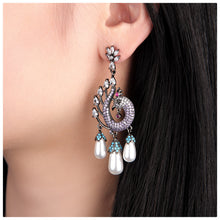 Cargar imagen en el visor de la galería, UJOY Peacock Inspired Drop Earrings – Gunmetal Tone with Purple Crystals &amp; Pearl Tassels